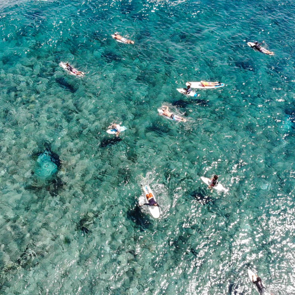 Birds eye view of our group enjoying the warm crystal clear water and the perfectly smooth waves.
