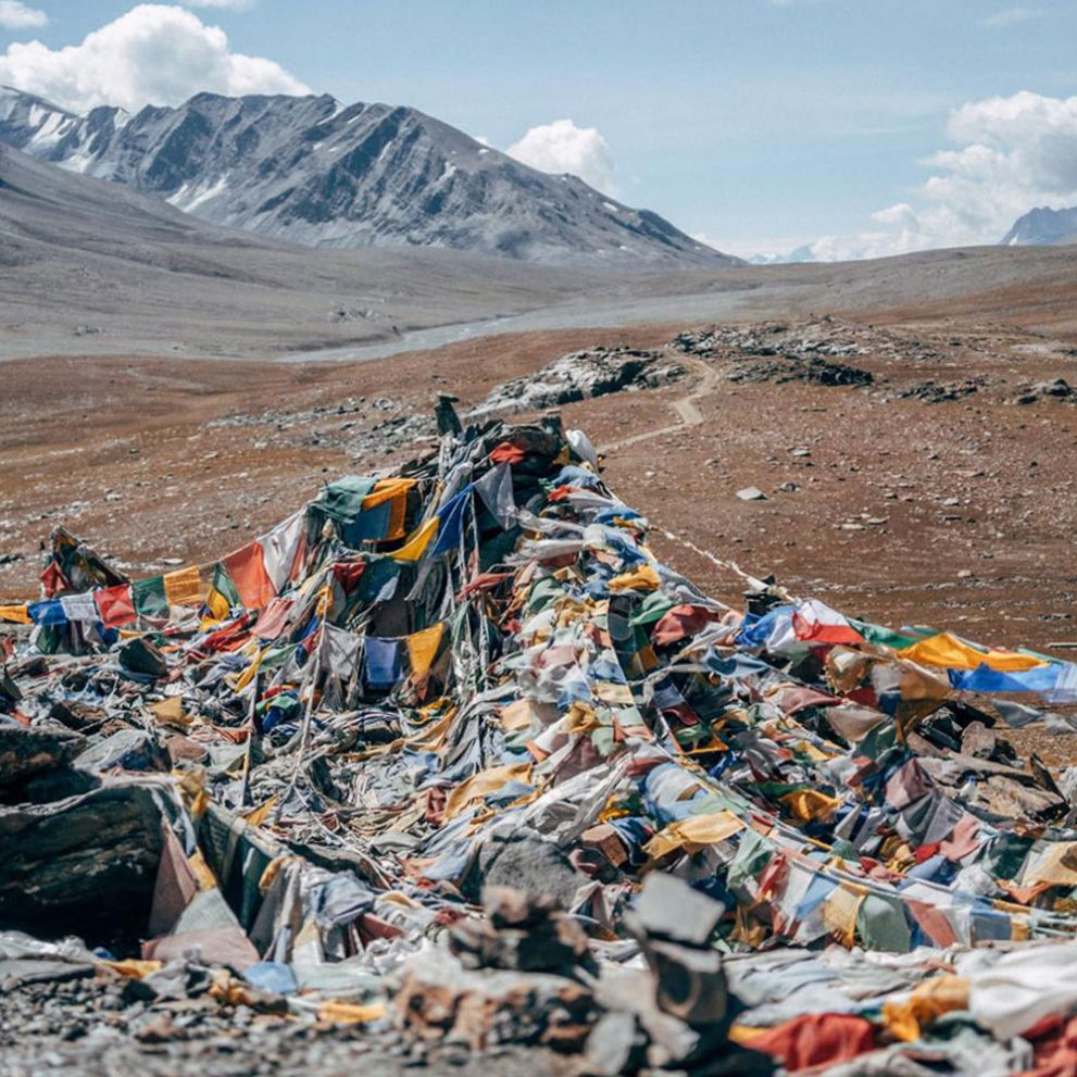 The mantras of the prayer flags are carried by the wind, spreading peace, compassion, strength, and wisdom.