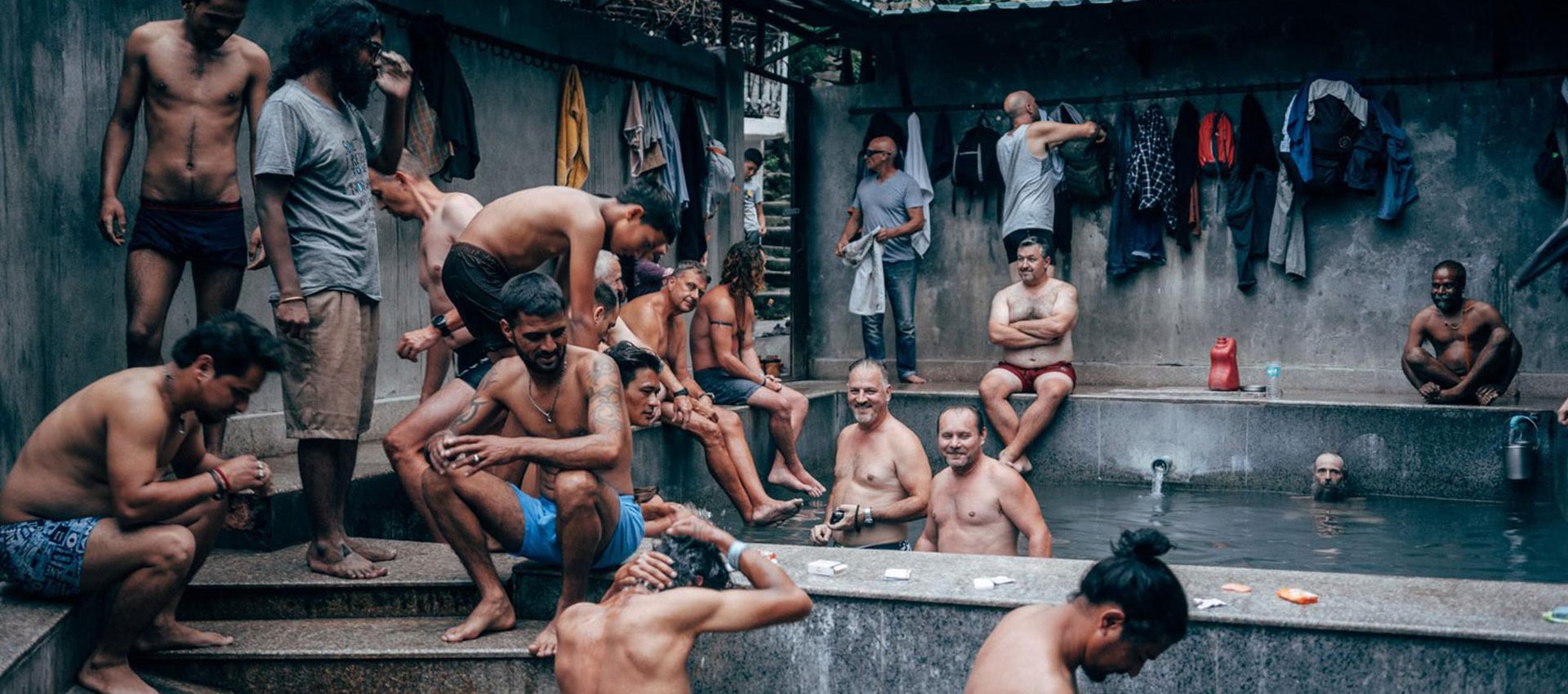 After a hard day of riding the group is relaxing in the public hot thermal bath of Manali while chatting with the locals.